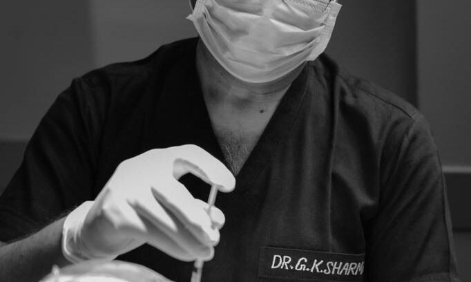 Doctor performing a hair transplant procedure on a patient.